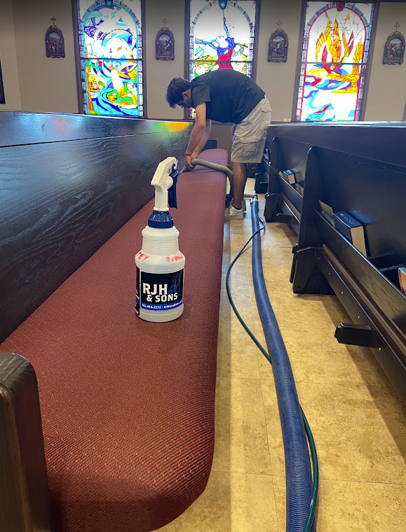 RJH and Sons technician steam cleaning upholstered church pews in the Texas Hill Country